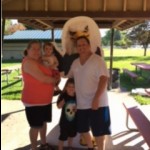 Family poses in front of Auggie Eagle standup